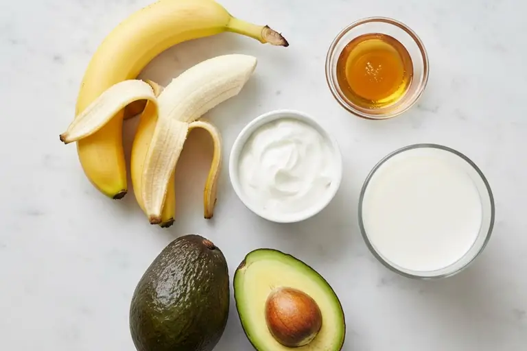 Banana, avocado, yogurt, and almond milk on counter